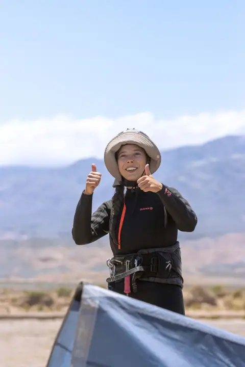 Alumna con casco lista para su clase de kitesurf